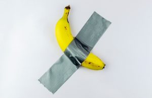 banana,duct,taped,to,the,white,wall.,conceptual,photo.